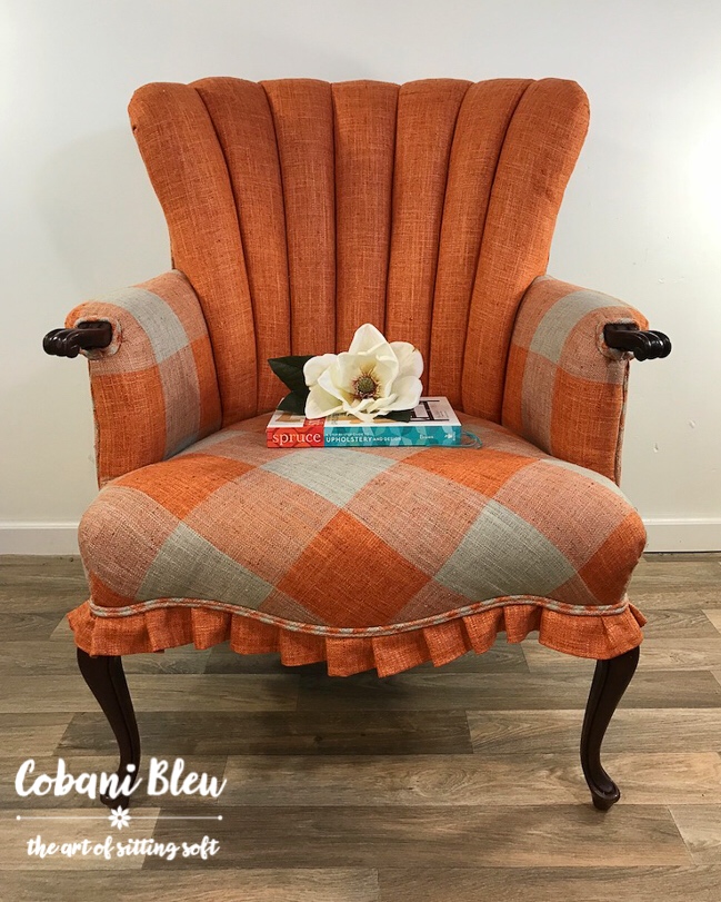 My finishes channel back chair in orange and gray buffalo check.